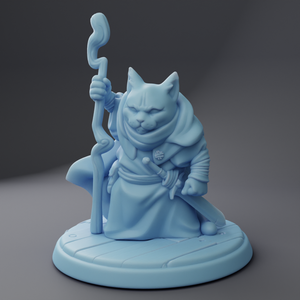 a blue statue of a cat holding a staff