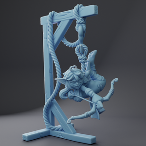 a blue figurine of a woman climbing a rope