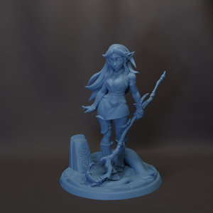 A figurine of a female character with long hair and a staff, standing on a base with a skull-like design.