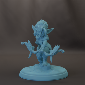 A figurine of a small, winged creature with a pointed hat and ornate clothing, standing on a pedestal.