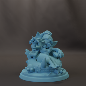 A light blue figurine of a person sitting on a rock, holding a small object in their hand.