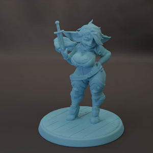 A figurine of a female character with a sword, standing on a circular base.
