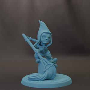 A blue, cartoonish-looking figurine of a character with a pointed hat and a broom, sitting on a circular base.