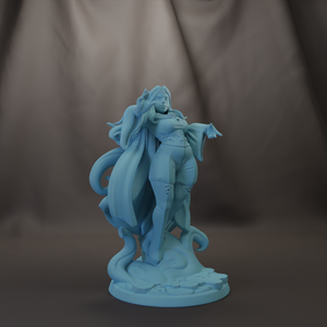 A figurine of a woman with flowing hair and a flowing robe, standing on a rock and pointing upwards.