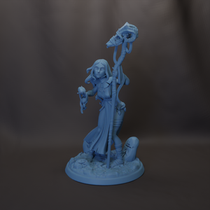 A 3D model of a female character with long hair, holding a staff and a staff-like object, standing on a base with a rock formation.