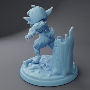 a blue figurine of a creature standing on a rock