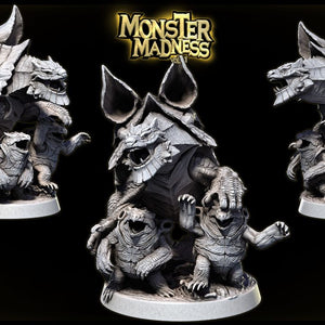 The image is a 3D rendering of a monster-themed figurine, featuring a large dragon-like creature with sharp teeth and claws, surrounded by smaller monster-like creatures. The figurine is set against a dark background, and there is text in the top right corner that reads "MONSTER MADNESS".