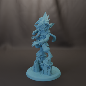 A light blue figurine of a character with a pointed hat and flowing hair, standing on a base with rocks and plants.