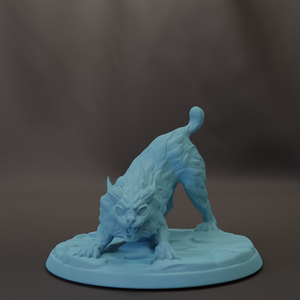 A light blue, sculpted figurine of a cat with a fierce expression, standing on a round base.