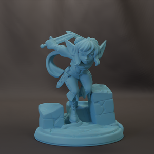 A figurine of a female character with a sword, standing on a rock formation.