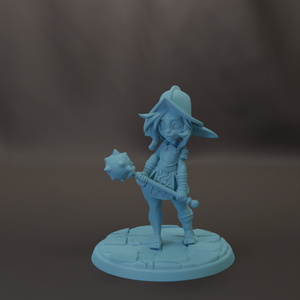 A figurine of a young girl holding a weapon, standing on a platform.