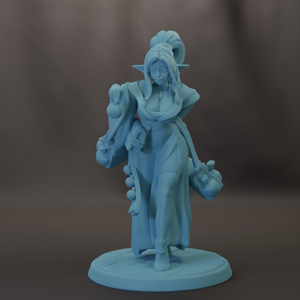 A figurine of a woman with a long, flowing dress and a large headdress, standing on a platform and holding a small object in her hand.