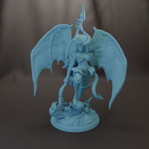 A figurine of a winged, winged creature with a human-like body, standing on a base and holding a weapon.