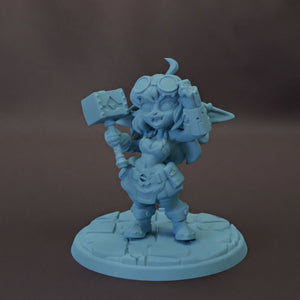 A figurine of a young girl with a hammer and a crescent moon on her head, standing on a stone base.