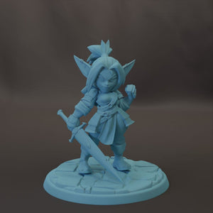 A figurine of a young girl with large ears, holding a sword and standing on a stone base.