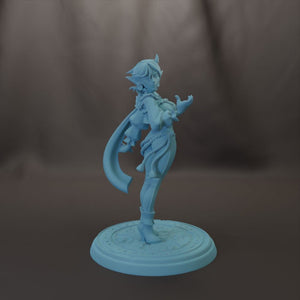 A figurine of a female character with a flowing cape and intricate design, standing on a circular base.