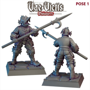 two miniature figures of medieval knights, each holding a large weapon.