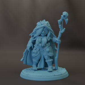 A figurine of a female character with a long, flowing robe and a headdress, holding a staff and a staff-like object.