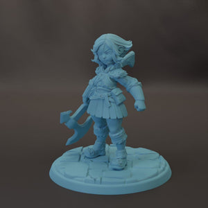 A figurine of a young girl holding a weapon, standing on a stone base.