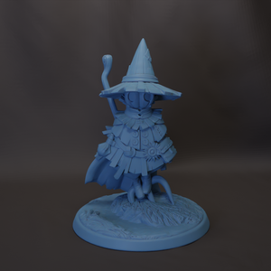 A blue figurine of a wizard or magical character, wearing a pointed hat and holding a staff, standing on a base with a design.