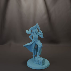 A figurine of a pirate standing on a chest, holding a sword and shield, against a dark background.