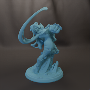 A light blue figurine of a female character with a flowing cape and sword, standing on a base with rocks.