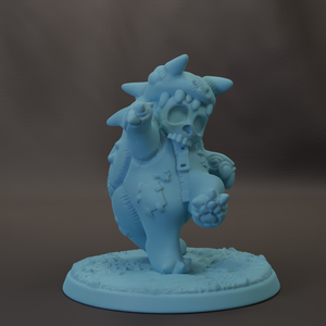 A light blue, skull-like figurine with horns and a skull-like face stands on a base, appearing to be a whimsical or fantastical character.