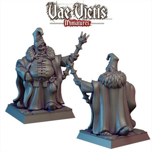 two figurines of a wizard, one standing and one kneeling, both wearing robes and hats.
