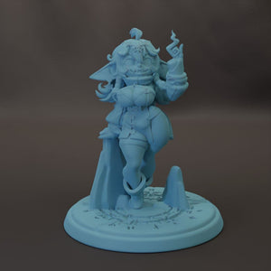 A figurine of a female character with a unique design, standing on a base with a circular pattern.