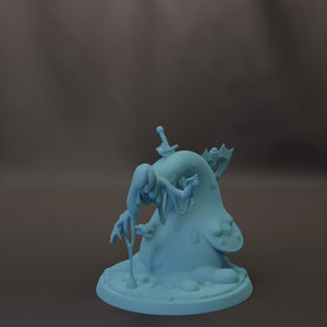 A light blue figurine of a person with a sword and a shield, sitting on a rock.