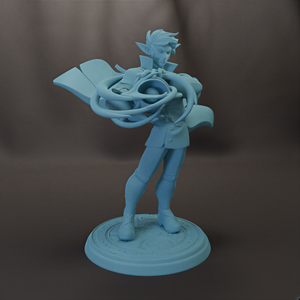 A figurine of a person holding a large, abstract object, possibly a musical instrument or a sculpture.