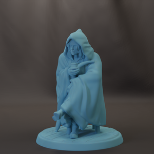 A light blue figurine of a person sitting on a bench, wearing a hooded cloak and holding a cup.
