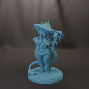 A light blue figurine of a woman with a pointed hat and a staff, standing on a circular base.