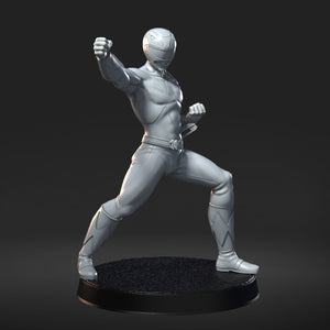 A silver statue of a superhero character in a fighting stance, standing on a black base.