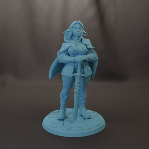 A figurine of a woman holding a sword and standing on a pedestal.
