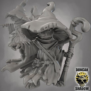 A 3D rendering of a wizard-like character with a pointed hat and a staff, standing against a dark background.