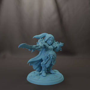 A figurine of a female character with a flowing cape and sword, standing on a base.