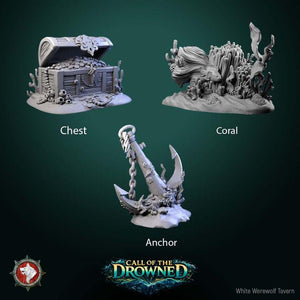 three different sculptures or figurines, each representing a different type of underwater scene: a chest, a coral, and an anchor.