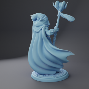 a blue statue of a wizard holding a flower