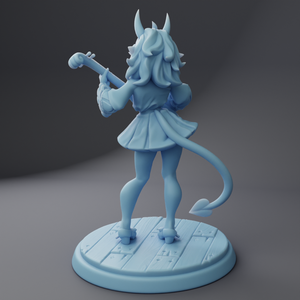 a figurine of a girl with horns and a sword